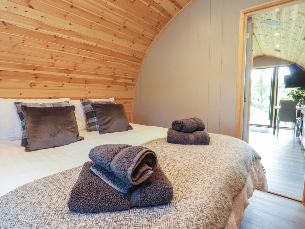 A bedroom with a bed and towels at Pendle in Nelson