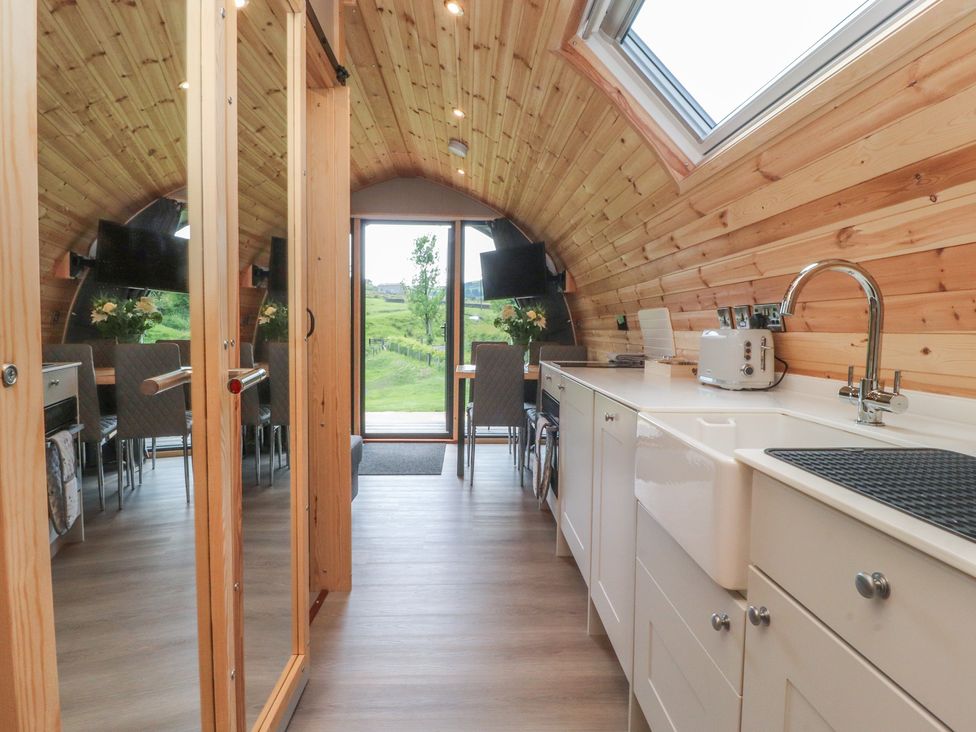 A kitchen with a sink and dining area at Pendle in Nelson