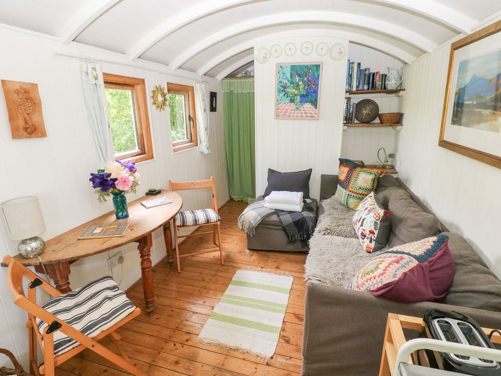 A living room with a sofa and table at The Shephard Hut near Solva