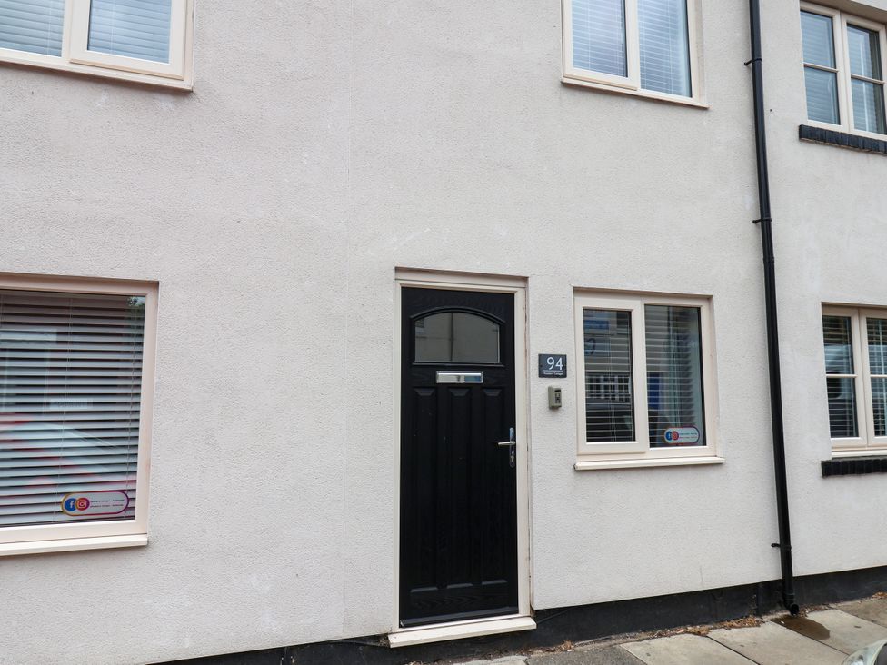 Front of a house featuring a black door and windows at 94 Church Street in Guisborough