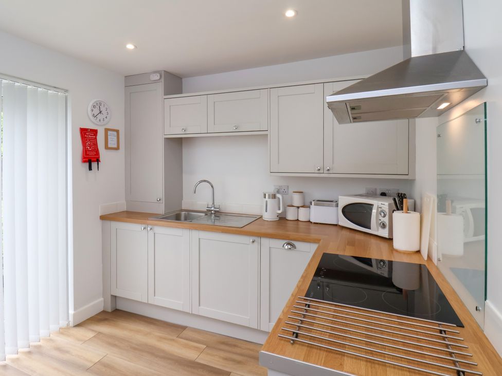 A kitchen with cabinets, sink, and appliances at 94 Church Street in Guisborough