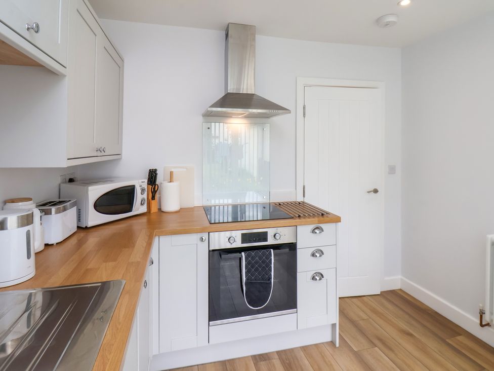 A kitchen with appliances and cabinets at 94 Church Street in Guisborough