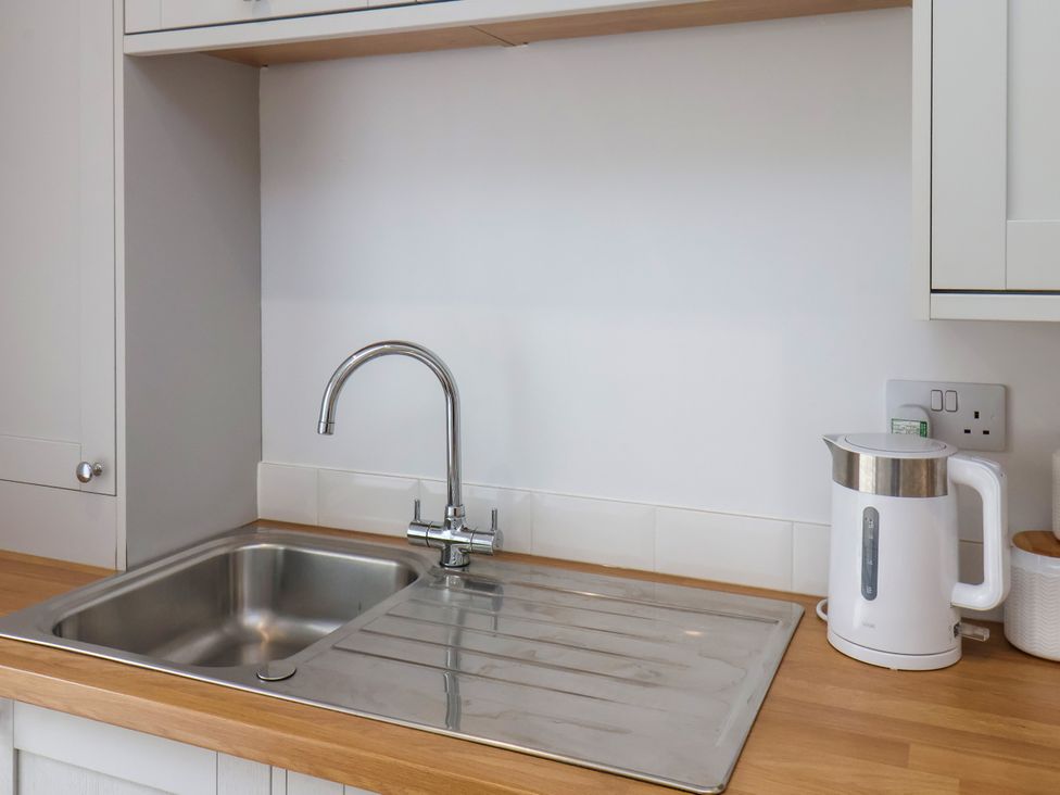 A kitchen with a sink and kettle at 94 Church Street Guisborough