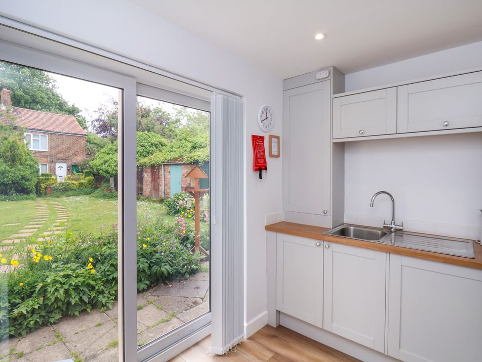 A kitchen with a sink and cabinets at 94 Church Street in Guisborough