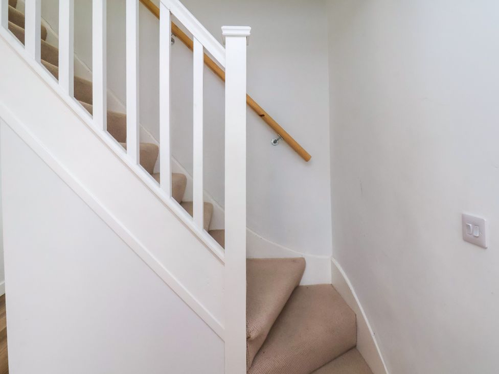 A staircase with a handrail and carpet at 94 Church Street in Guisborough