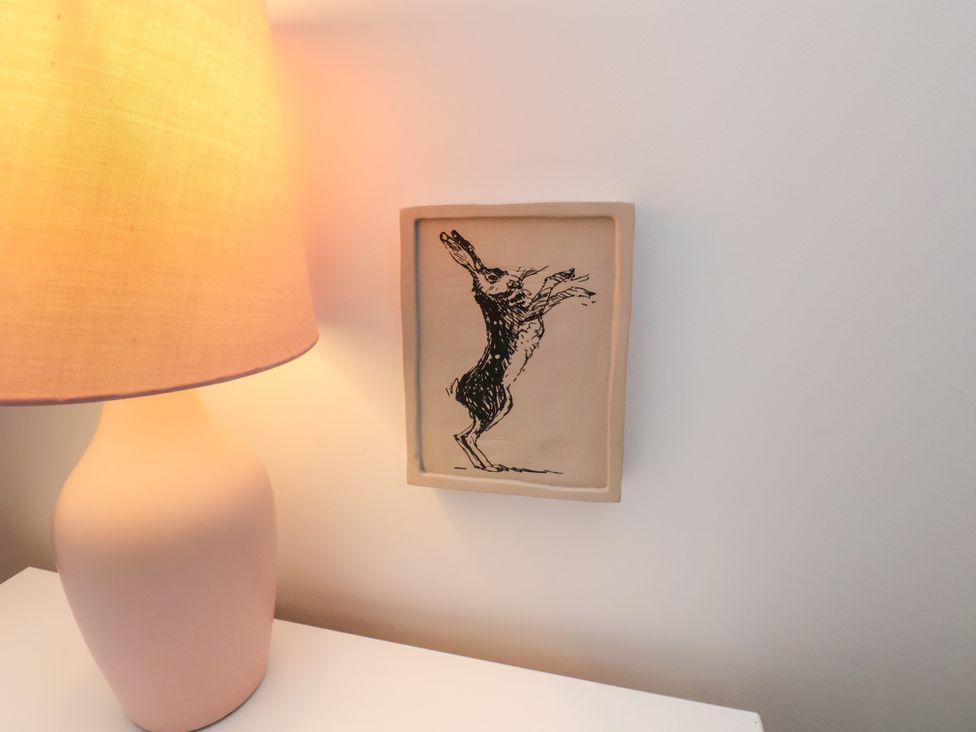 A lamp and framed drawing on a wall at 94 Church Street in Guisborough