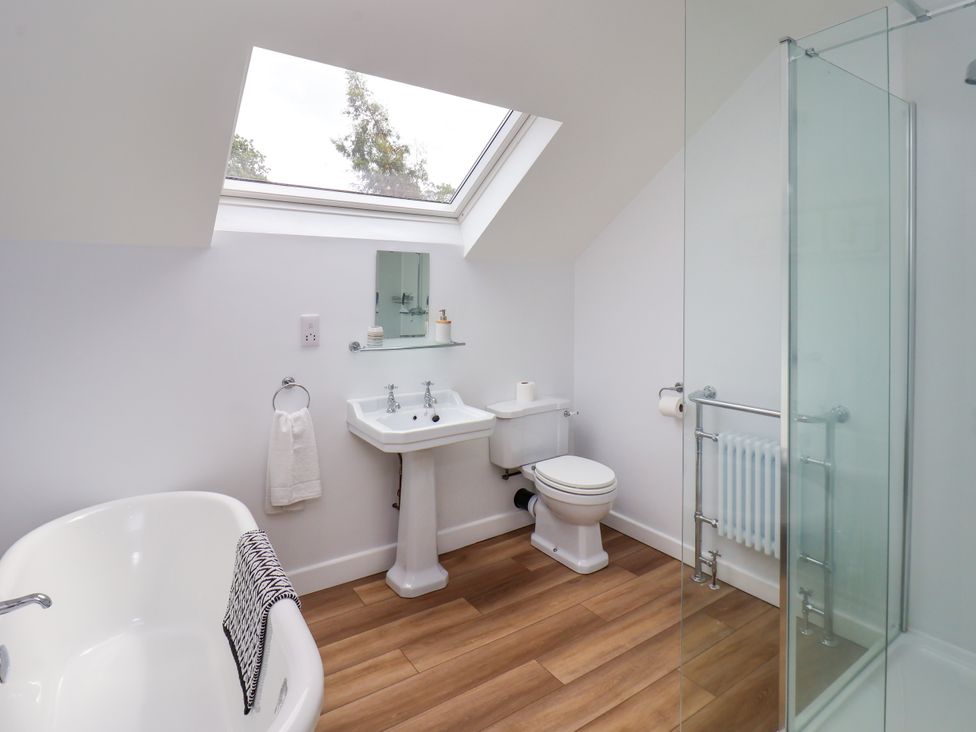 A bathroom with a bathtub, sink, shower and toilet at 94 Church Street in Guisborough