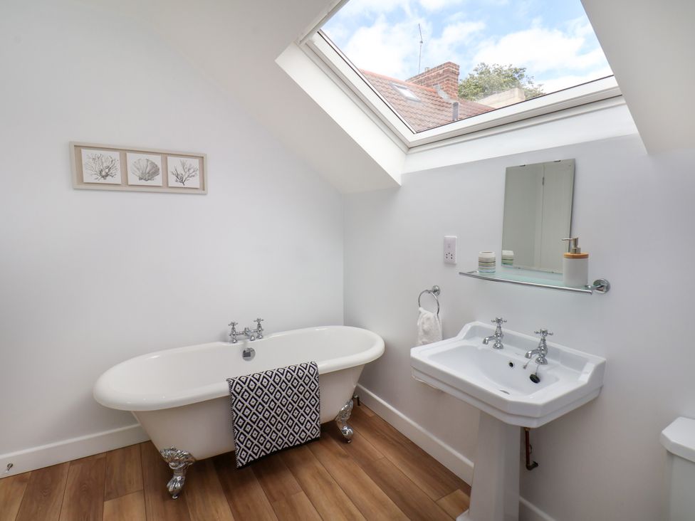 A bathroom with a bathtub and sink at 94 Church Street Guisborough