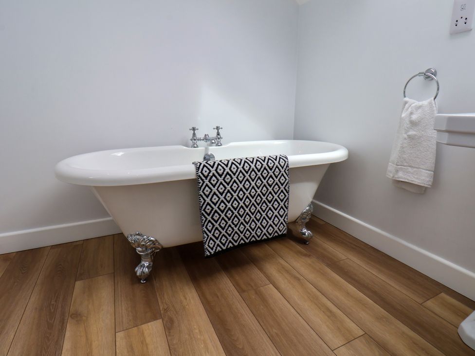 A bathroom with a bathtub and towel holder at 94 Church Street in Guisborough