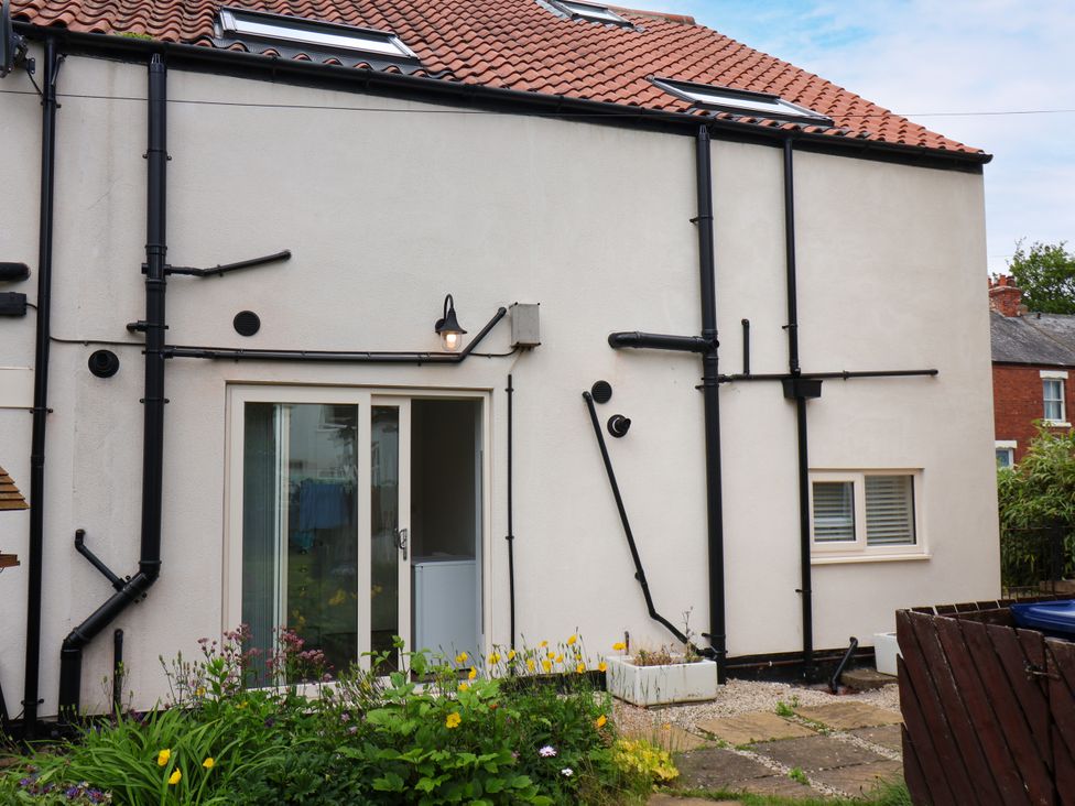 The exterior of a house with windows and a flower bed at 94 Church Street Guisborough