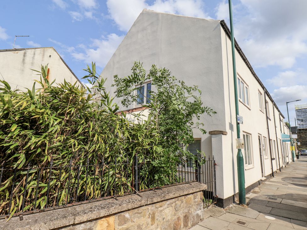 A building with bushes and a sidewalk at 96 Church Street in Guisborough