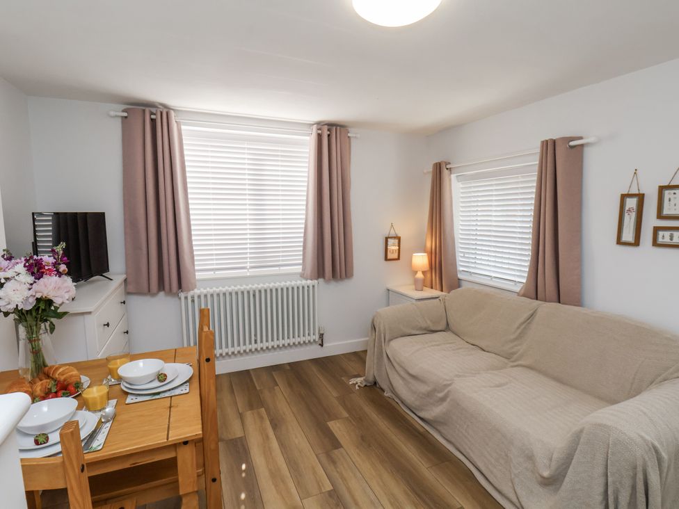 A living room with a sofa and dining table at 96 Church Street in Guisborough