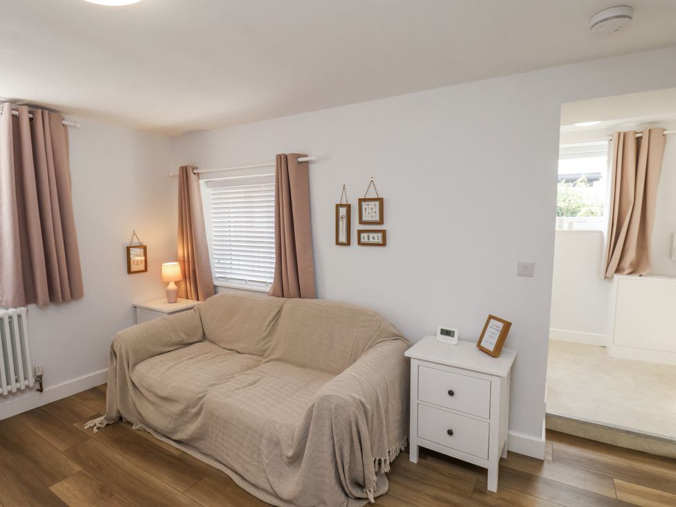 A living room with a sofa and curtains at 96 Church Street in Guisborough