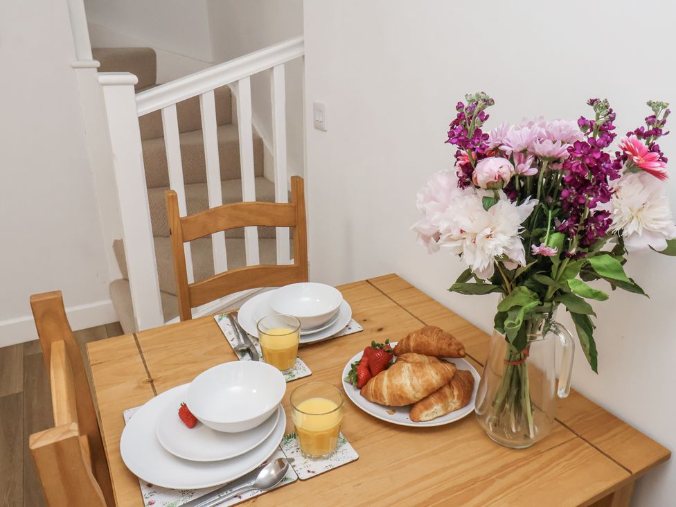 A dining table with bowls, juices, croissants and flowers at 96 Church Street in Guisborough