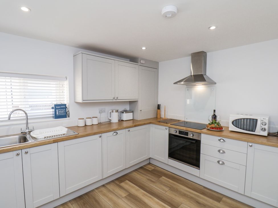 A kitchen with cabinets and appliances at 96 Church Street in Guisborough