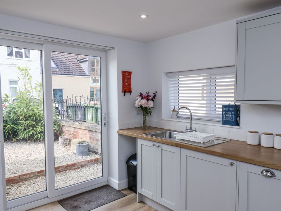 A kitchen with a sink and sliding door to the outside at 96 Church Street Guisborough