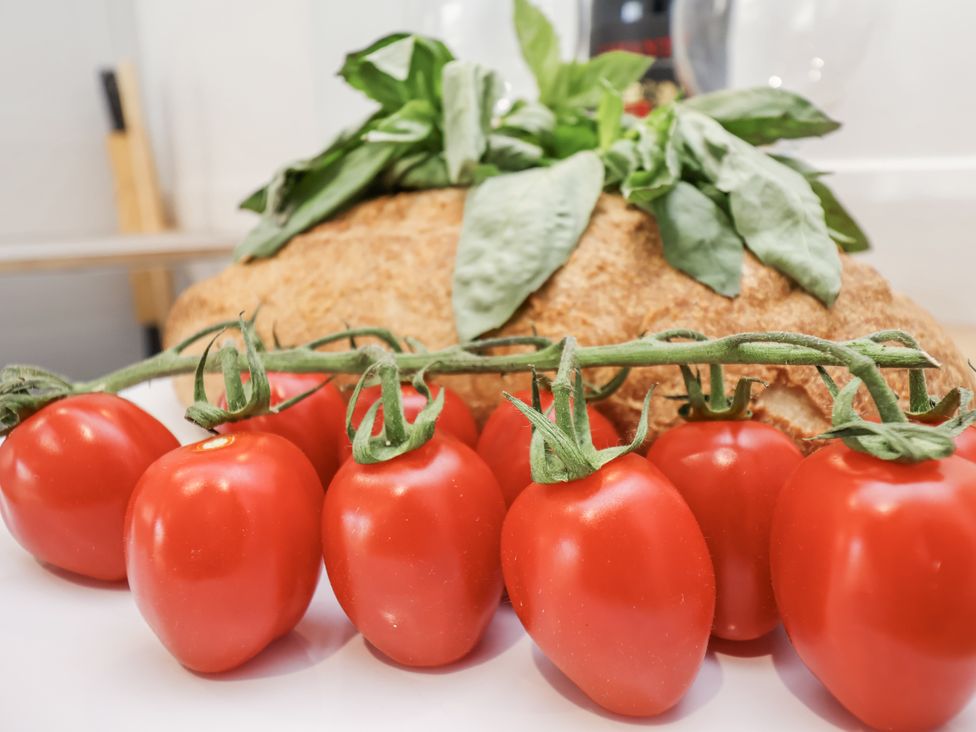 Red tomatoes with basil and bread on a table at 96 Church Street in Guisborough