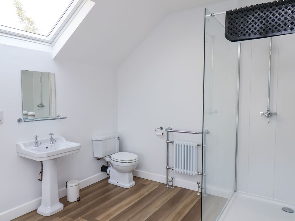 A bathroom with a sink, shower, and toilet at 96 Church Street Guisborough
