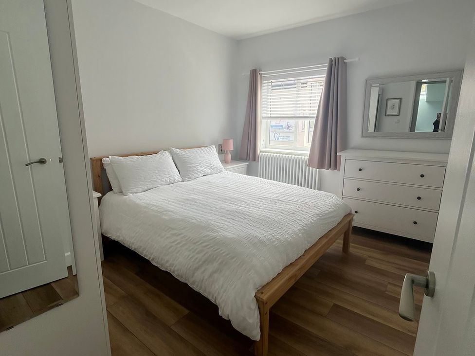 A bedroom with a bed and dresser at 96 Church Street in Guisborough