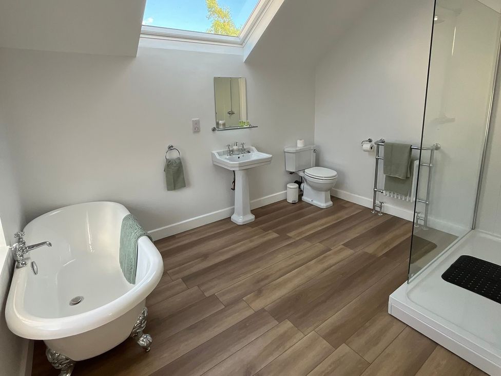 A bathroom with a bathtub and shower at 96 Church Street in Guisborough