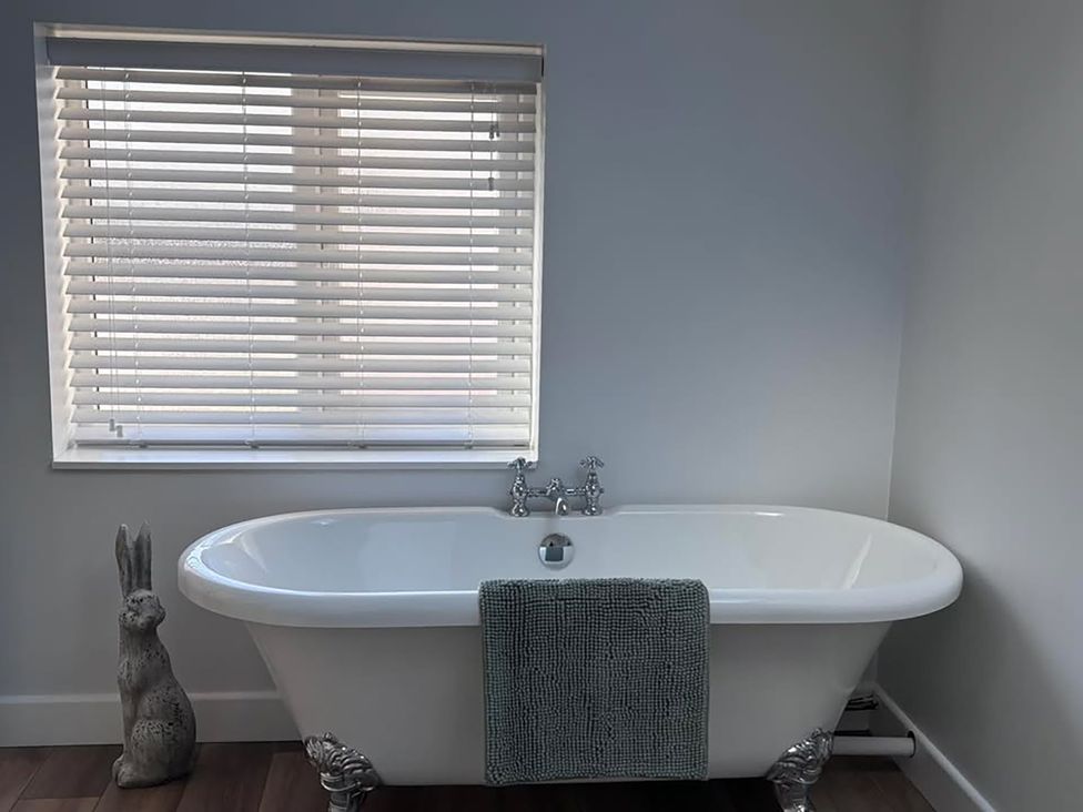 A bathroom with a bathtub, faucet, and towel at 96 Church Street, Guisborough