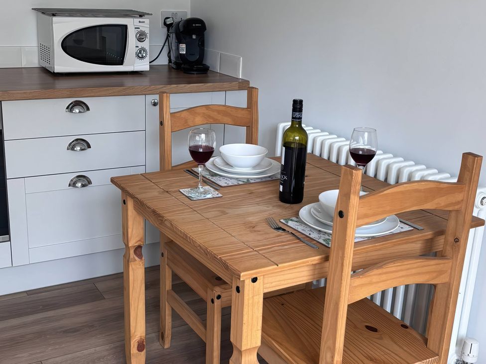 A dining room with a wooden table and chairs at 96 Church Street Guisborough