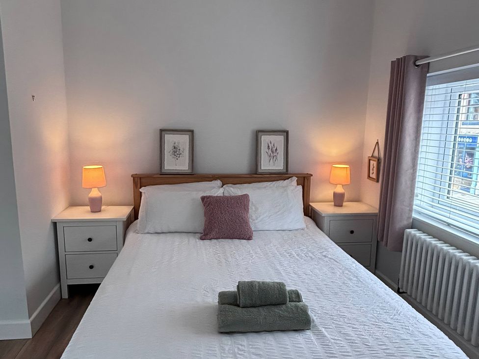 A bedroom with a bed and nightstands at 96 Church Street in Guisborough