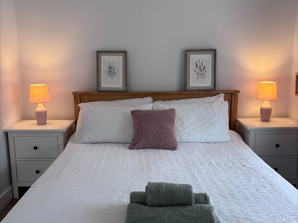 A bedroom with a bed and bedside tables at 96 Church Street in Guisborough