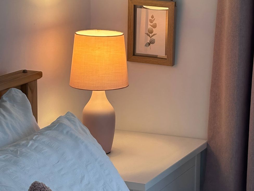 A bedside setup with a lamp and a picture frame at 96 Church Street in Guisborough