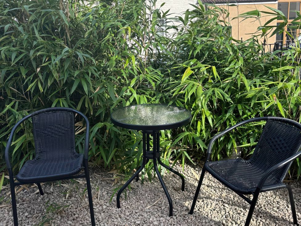 A table and two chairs in a garden at 96 Church Street Guisborough