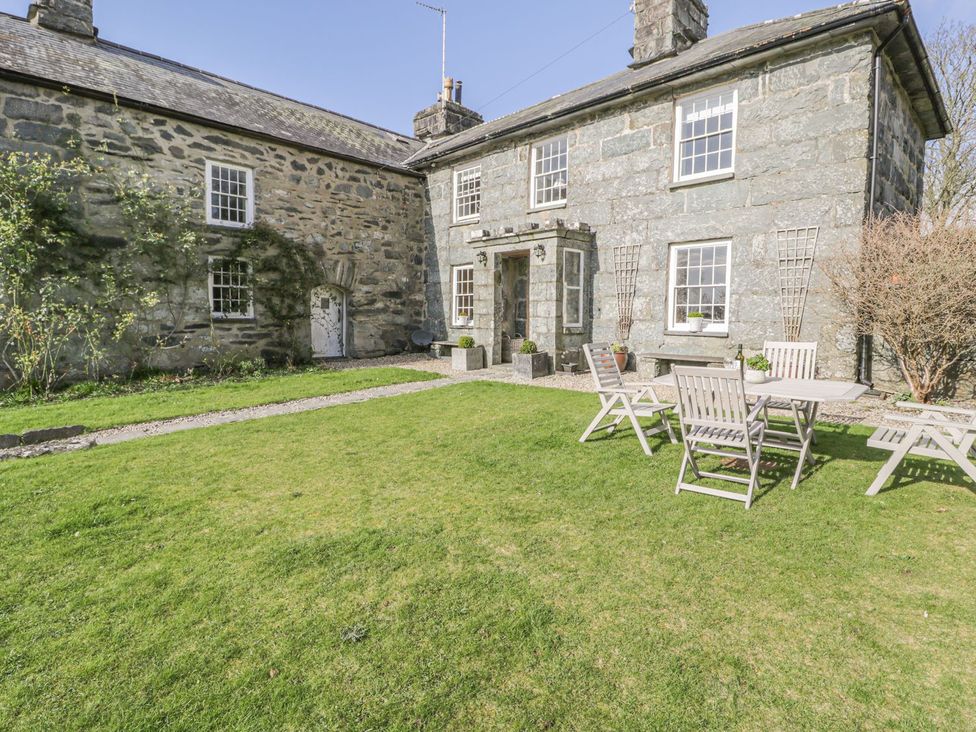 A house with a garden and outdoor seating at Bwthyn Morse Llanfair