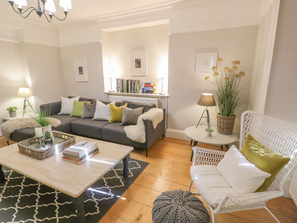 A living room with a sofa and coffee table at Bwthyn Morse in Llanfair