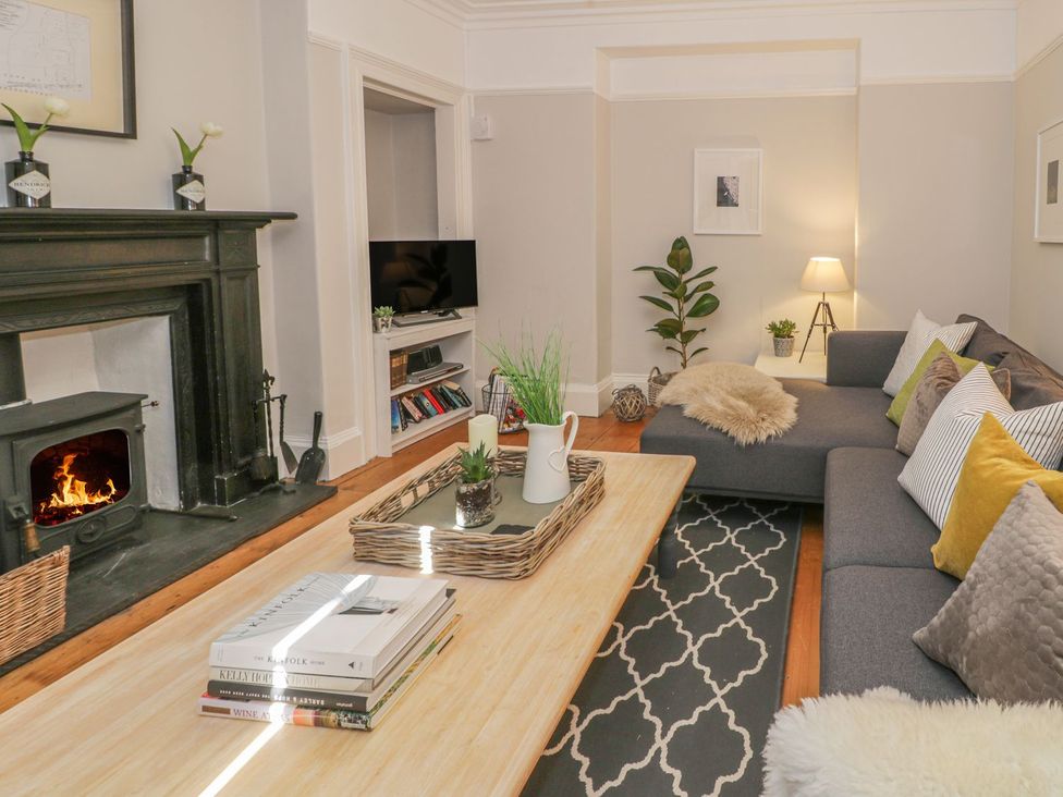 A living room with a fireplace and sofa at Bwthyn Morse in Llanfair