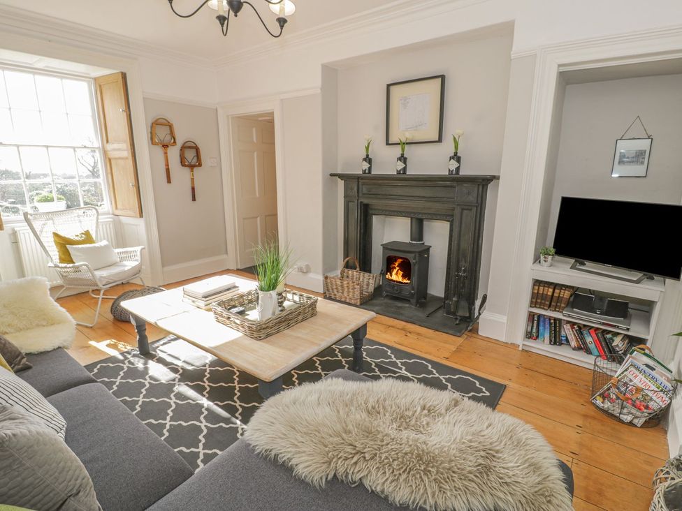 A living room with a fireplace and coffee table at Bwthyn Morse Llanfair