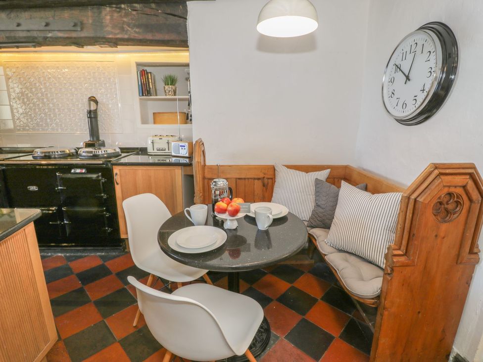 A kitchen with a table and chairs at Bwthyn Morse in Llanfair