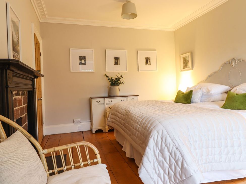 A bedroom with a bed and bedside table at Bwthyn Morse in Llanfair