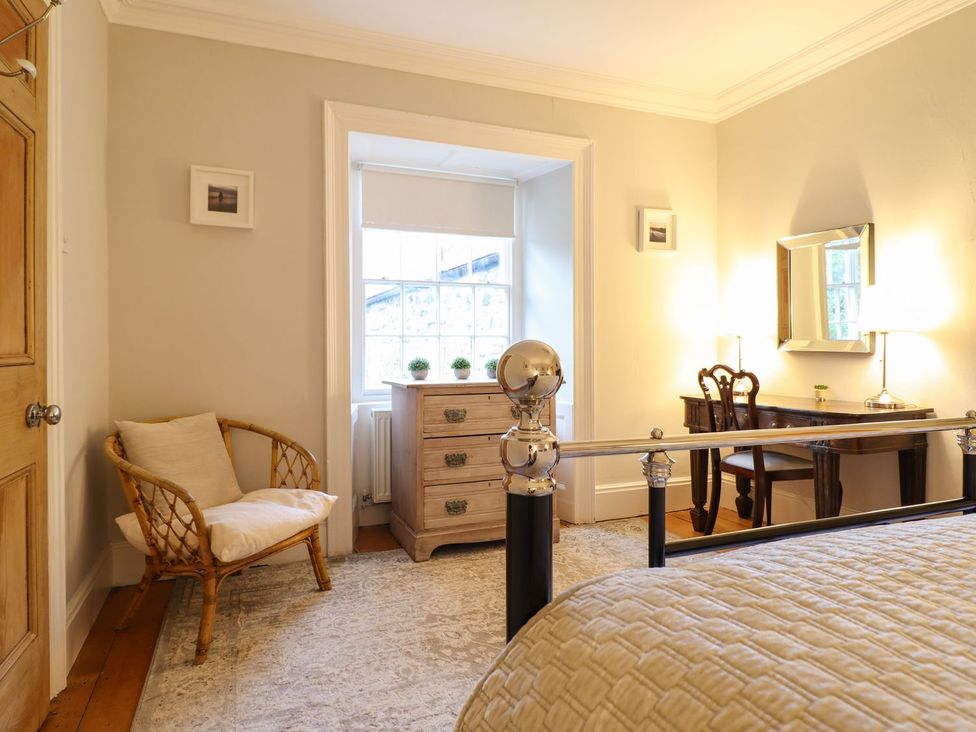 A bedroom with a bed and a dresser at Bwthyn Morse Llanfair