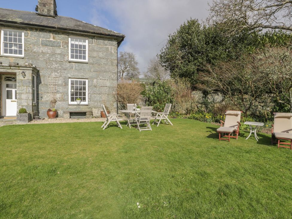 A garden with seating and a house at Bwthyn Morse in Llanfair
