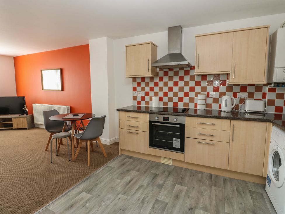 A kitchen with table and chairs at Curwen Apartment in Workington