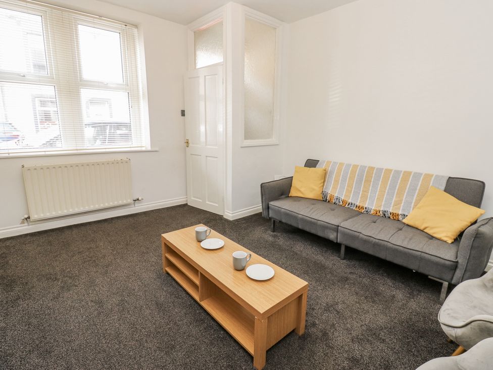 A living room with a sofa and coffee table at Cumberland House in Workington
