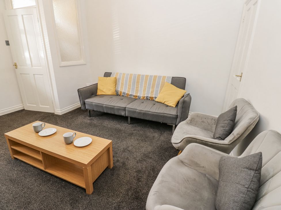 A living room with a sofa and coffee table at Cumberland House in Workington