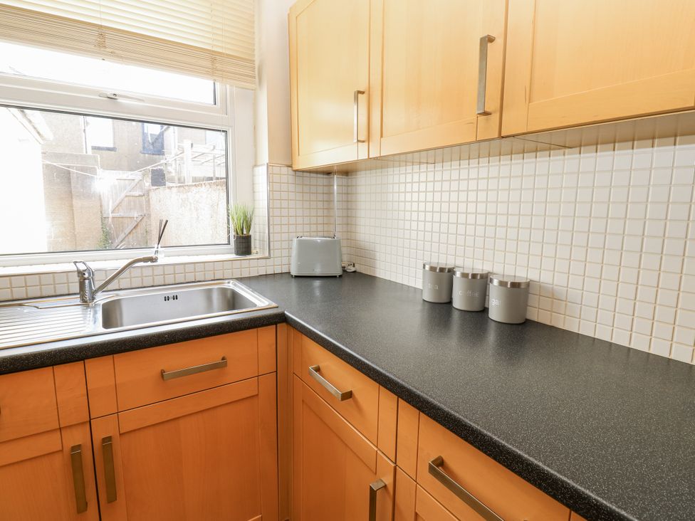 A kitchen with a sink and cabinet at Cumberland House in Workington