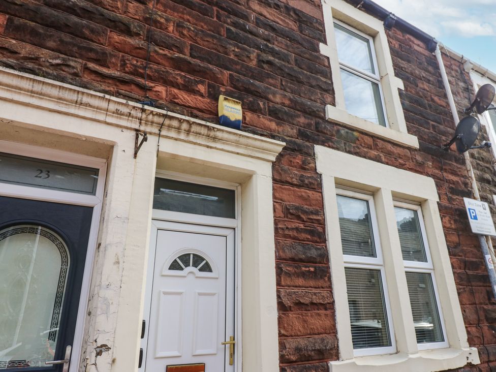 A building facade with front door and windows at Cumberland House in Workington
