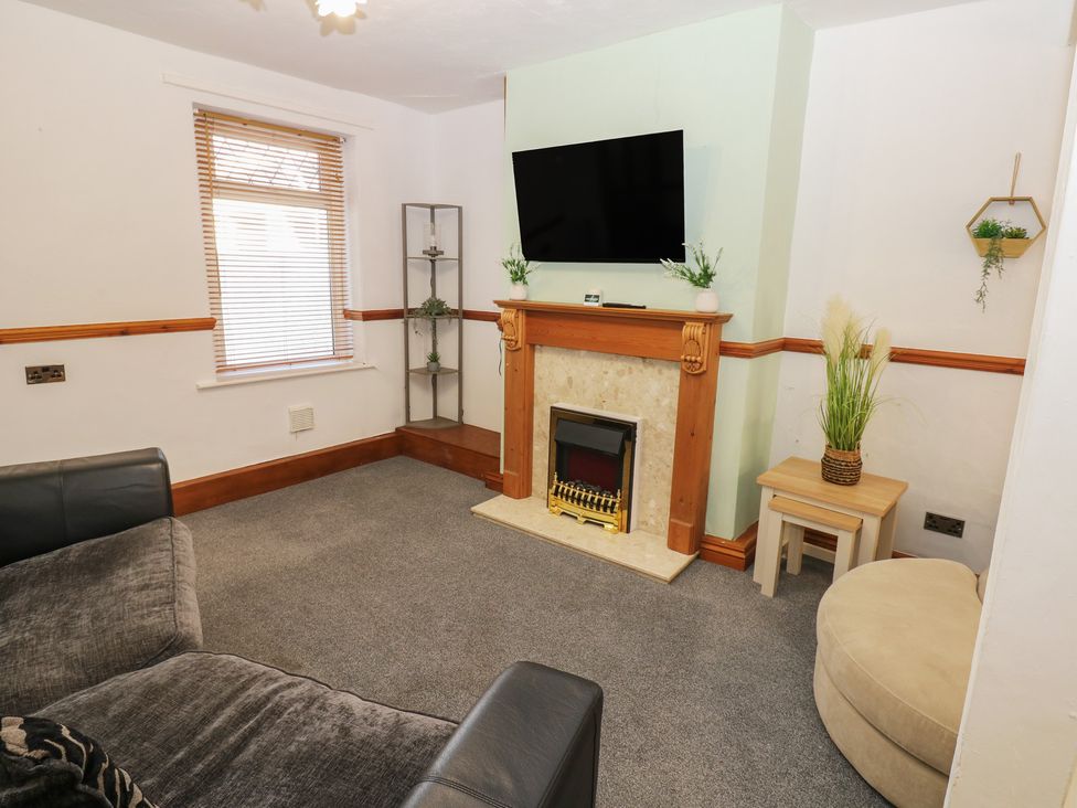 A living room with a fireplace and television at Bolton Terrace in Workington