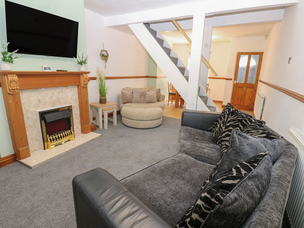 A living room with a fireplace and television at Bolton Terrace in Workington