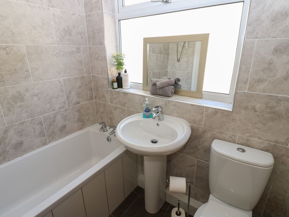 A bathroom with a bathtub, sink, and toilet at Bolton Terrace in Workington