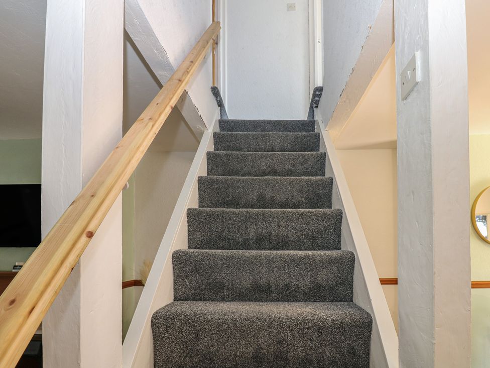 A staircase with carpet and a handrail at Bolton Terrace in Workington