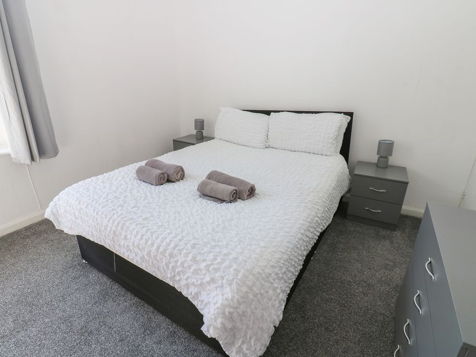 A bedroom with a bed and bedside tables at Bolton Terrace in Workington