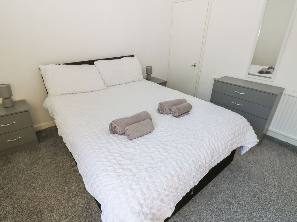 A bedroom with a bed and towels on it at Bolton Terrace in Workington