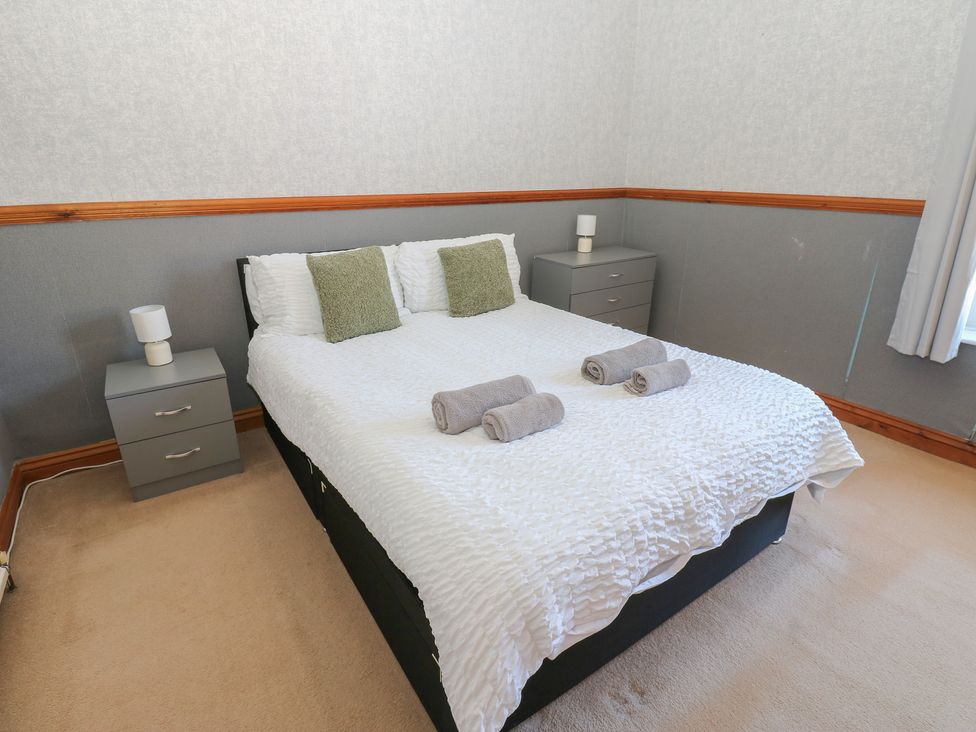 A bedroom with a bed and bedside tables at Bolton Terrace in Workington